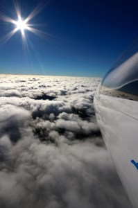 wave soaring in the sunlight above teh clouds not far away from the club